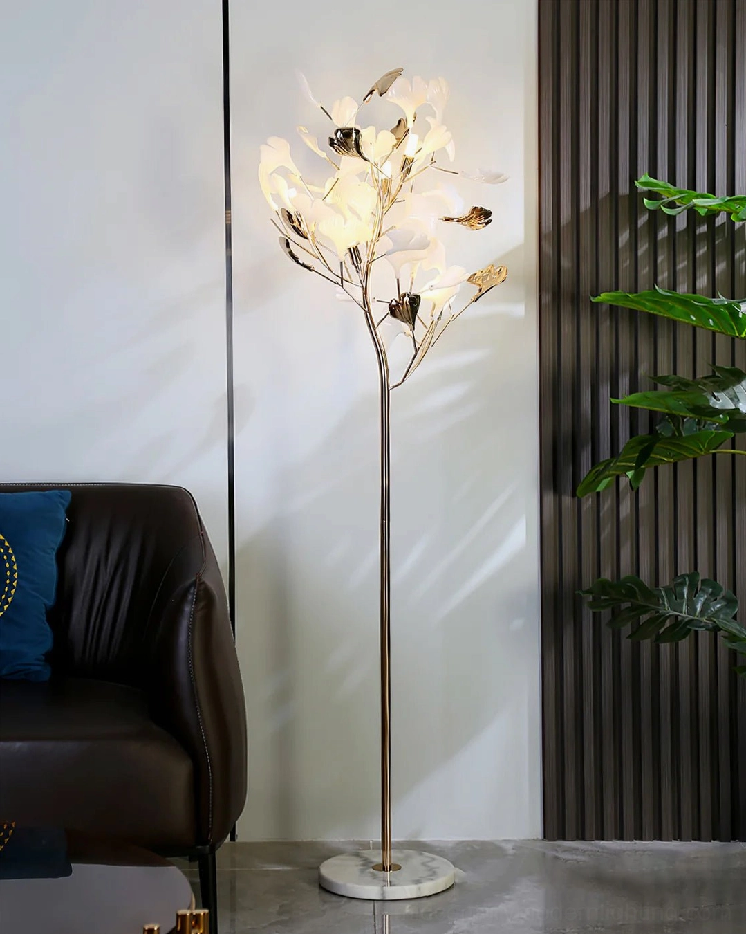 Ginkgo Leaf Floor Lamp with illuminated ceramic leaves, warm glow from five bulb sockets, gold metal stem, sculptural night ambiance