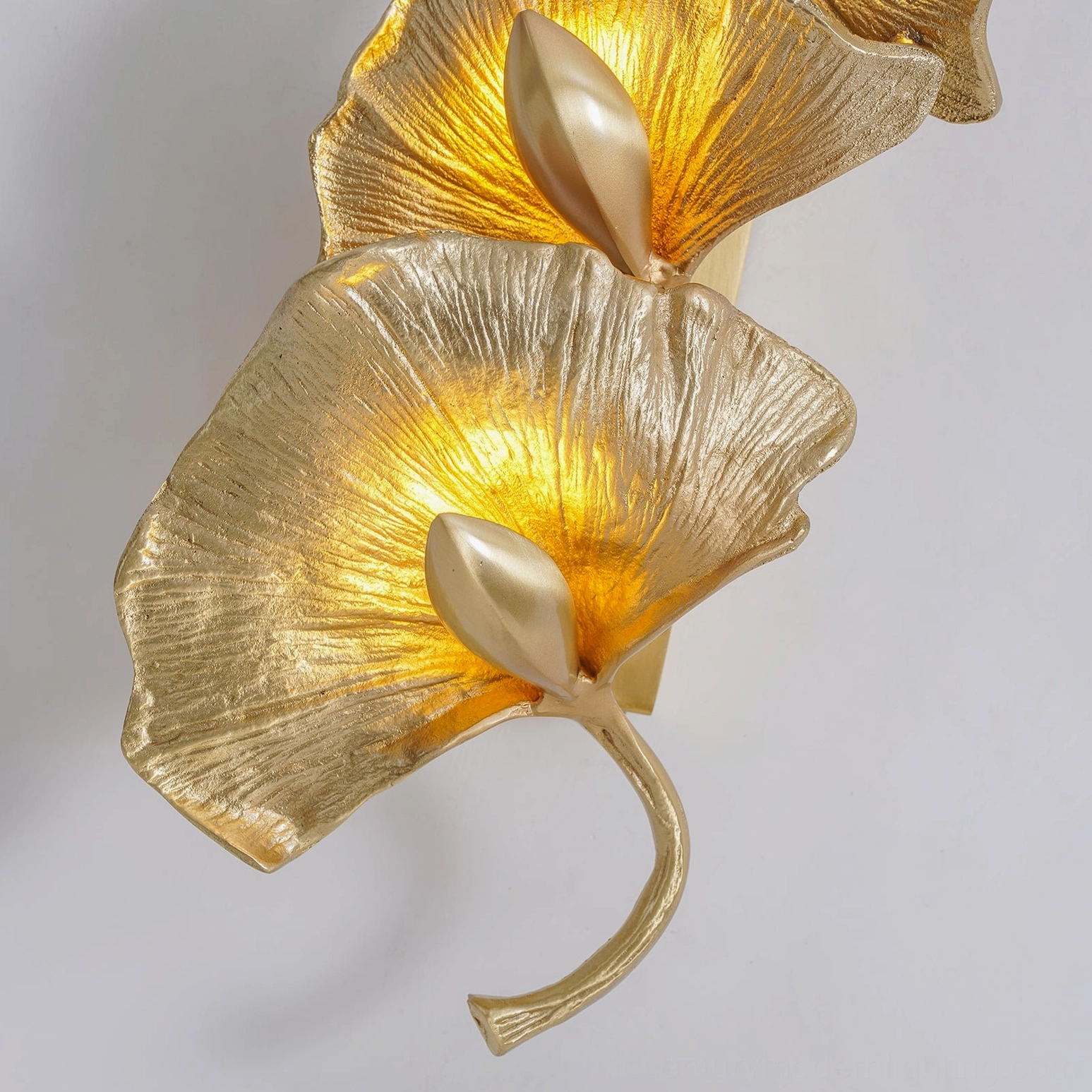 Ginkgo leaf wall sconce brass sculptural form warm glow gallery lighting mid-century