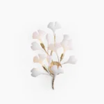 Ginkgo leaf wall sconce in gold and white ceramic, front view on studio white background, mid-century modern botanical light fixture