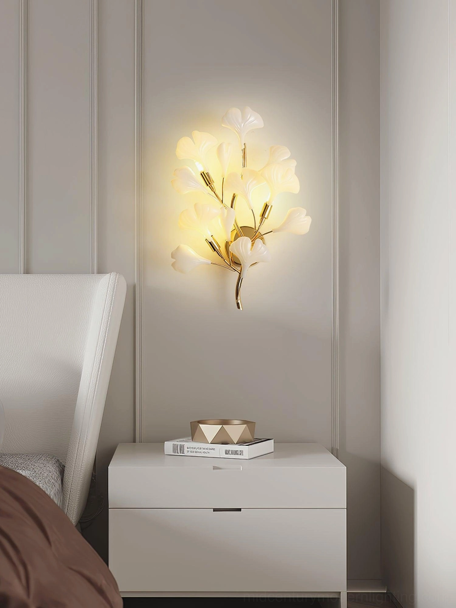 Ginkgo wall sconce Model A mounted above white bedside table, side perspective view, bedroom accent lighting