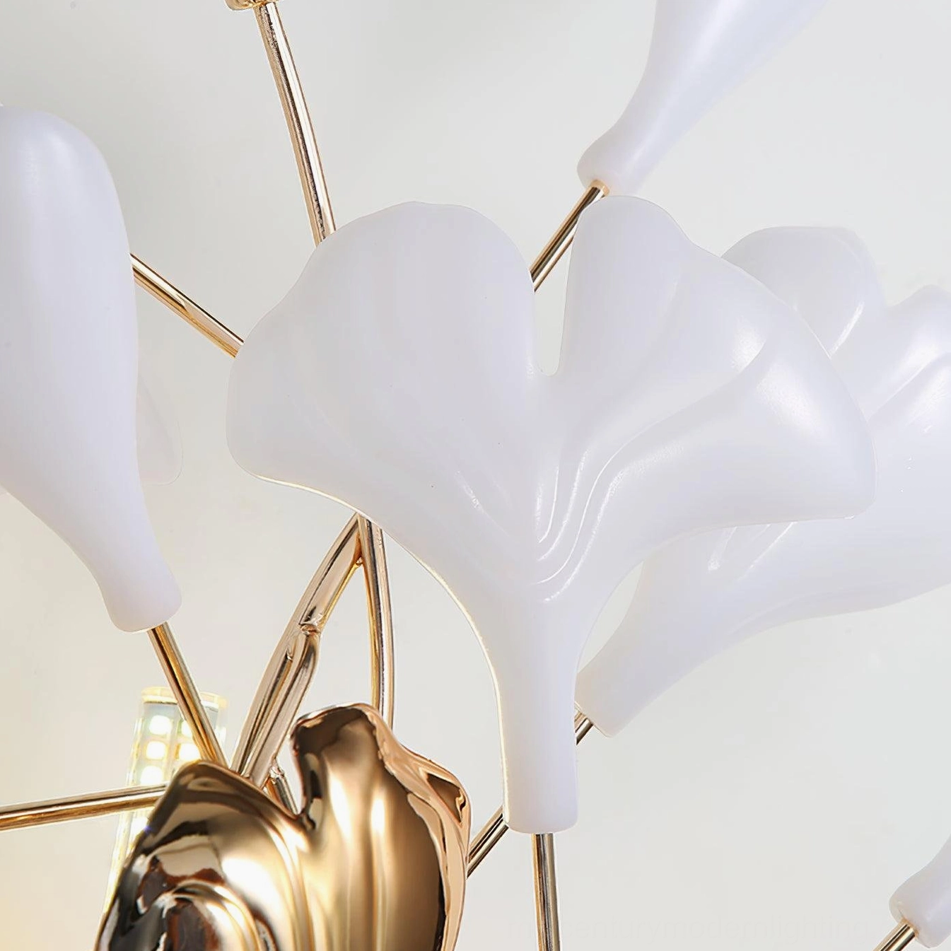 Ginkgo leaf sconce angled studio view, three-dimensional sculptural depth, metal and ceramic materials