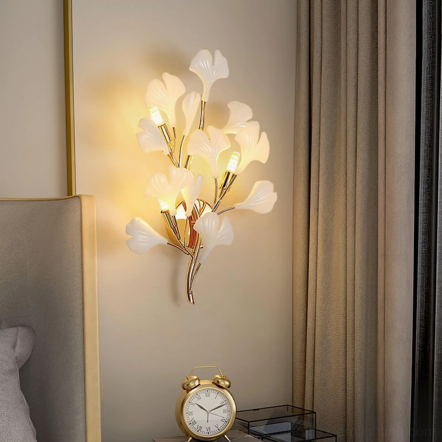 Ginkgo wall sconce bedside installation, side angle view above vintage nightstand with alarm clock and sheer curtain backdrop