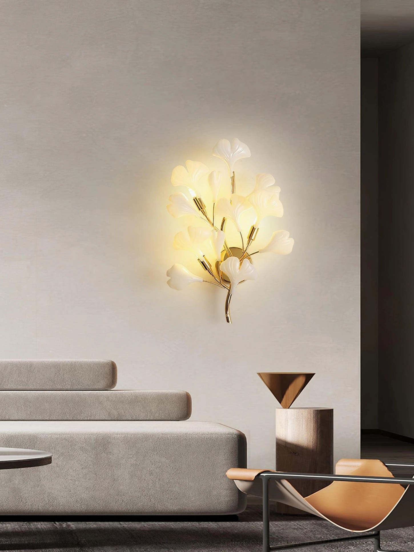 Ginkgo leaf sconce close-up frontal view on modern living room wall, minimalist decor, warm amber light cast