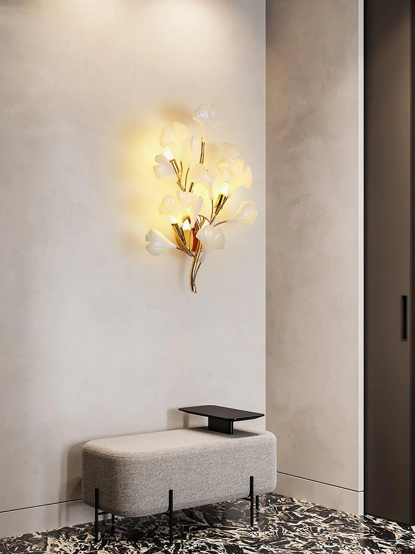 Ginkgo wall sconce installed in luxury lounge area with upholstered bench seating, soft warm light, light luxury interior