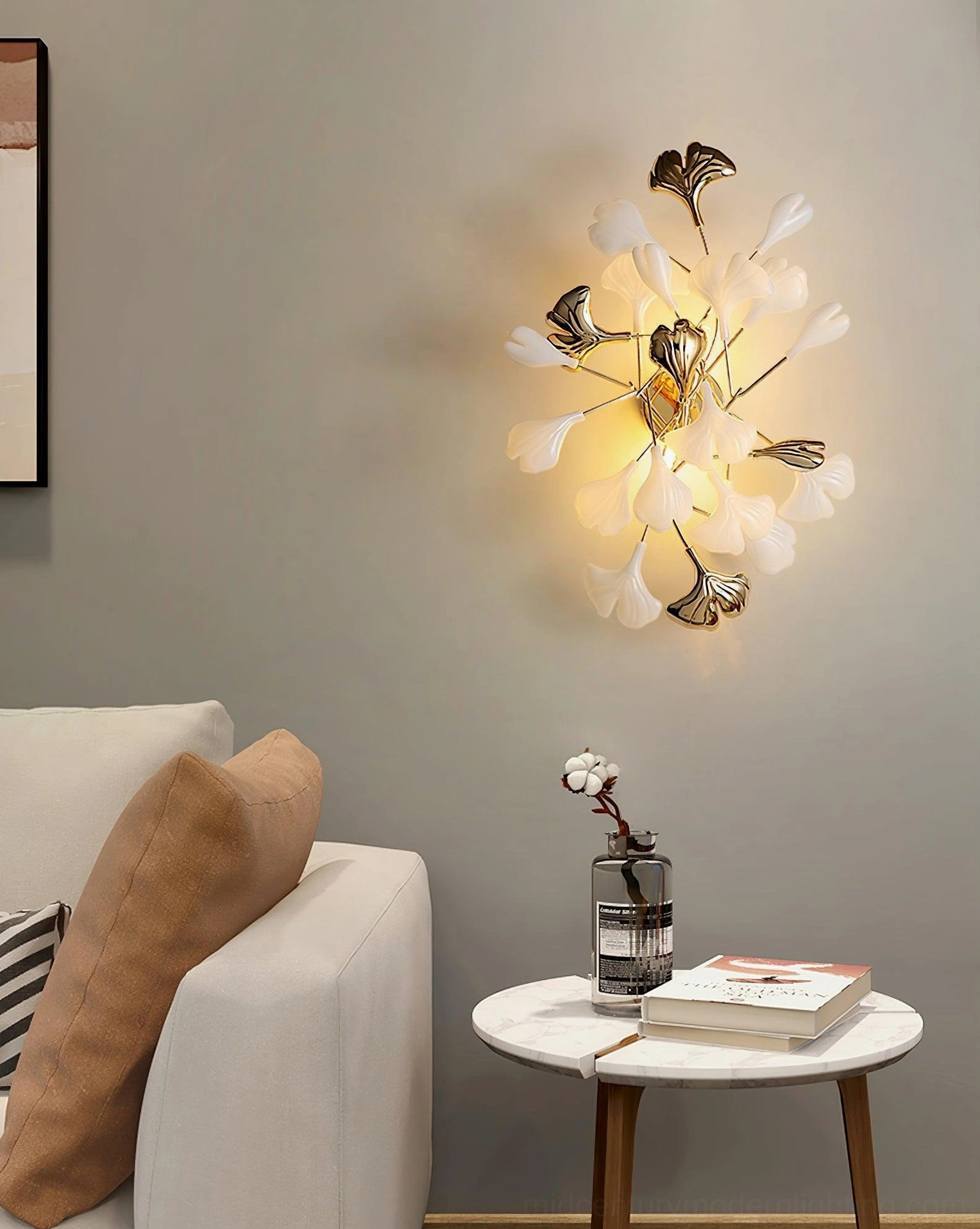 Ginkgo leaf wall sconce angled side view, gold metal framework with white ceramic leaf details, botanical sculptural form