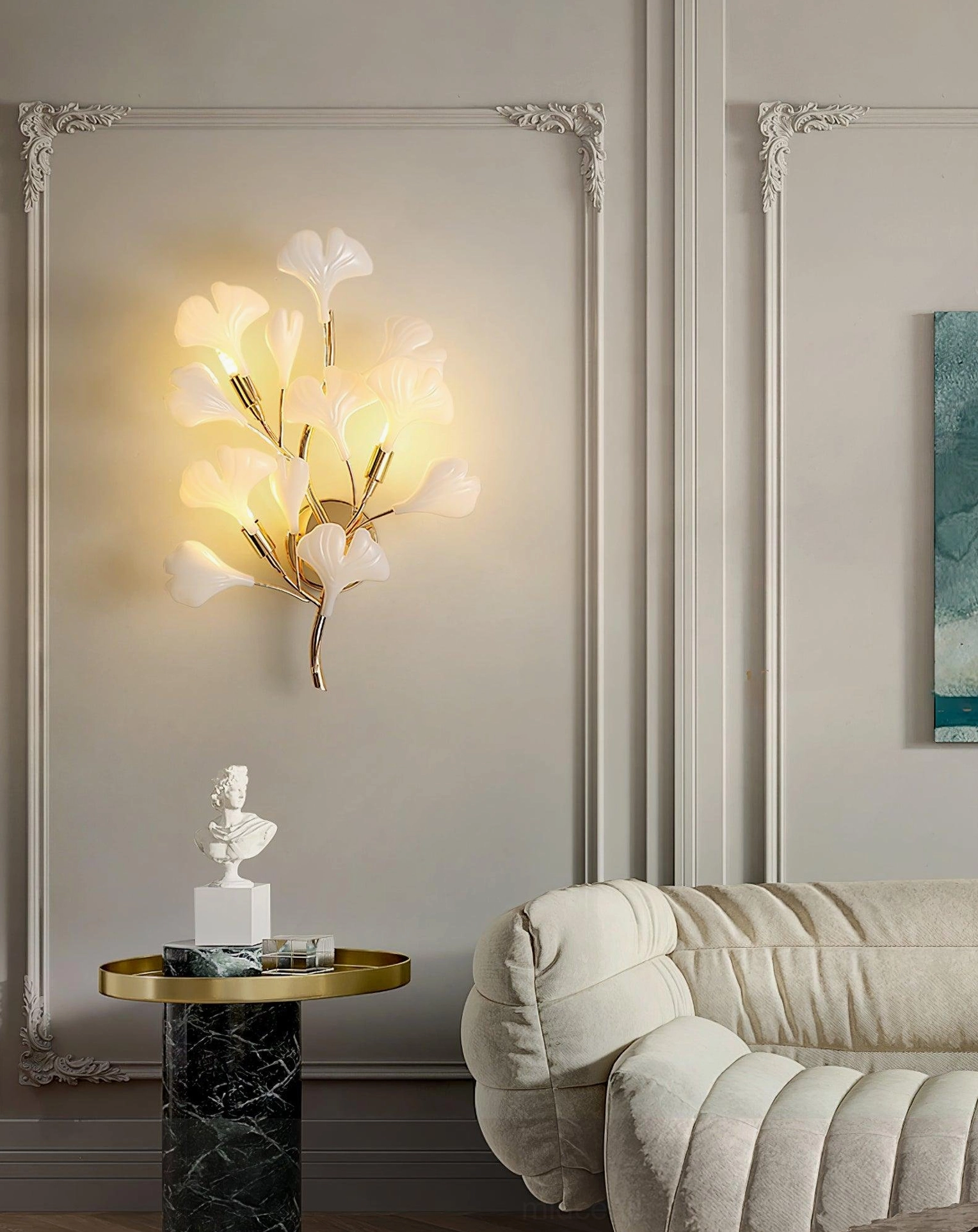 Ginkgo leaf wall sconce mounted in luxury living room with decorative wall trim, paired with side table and fabric sofa