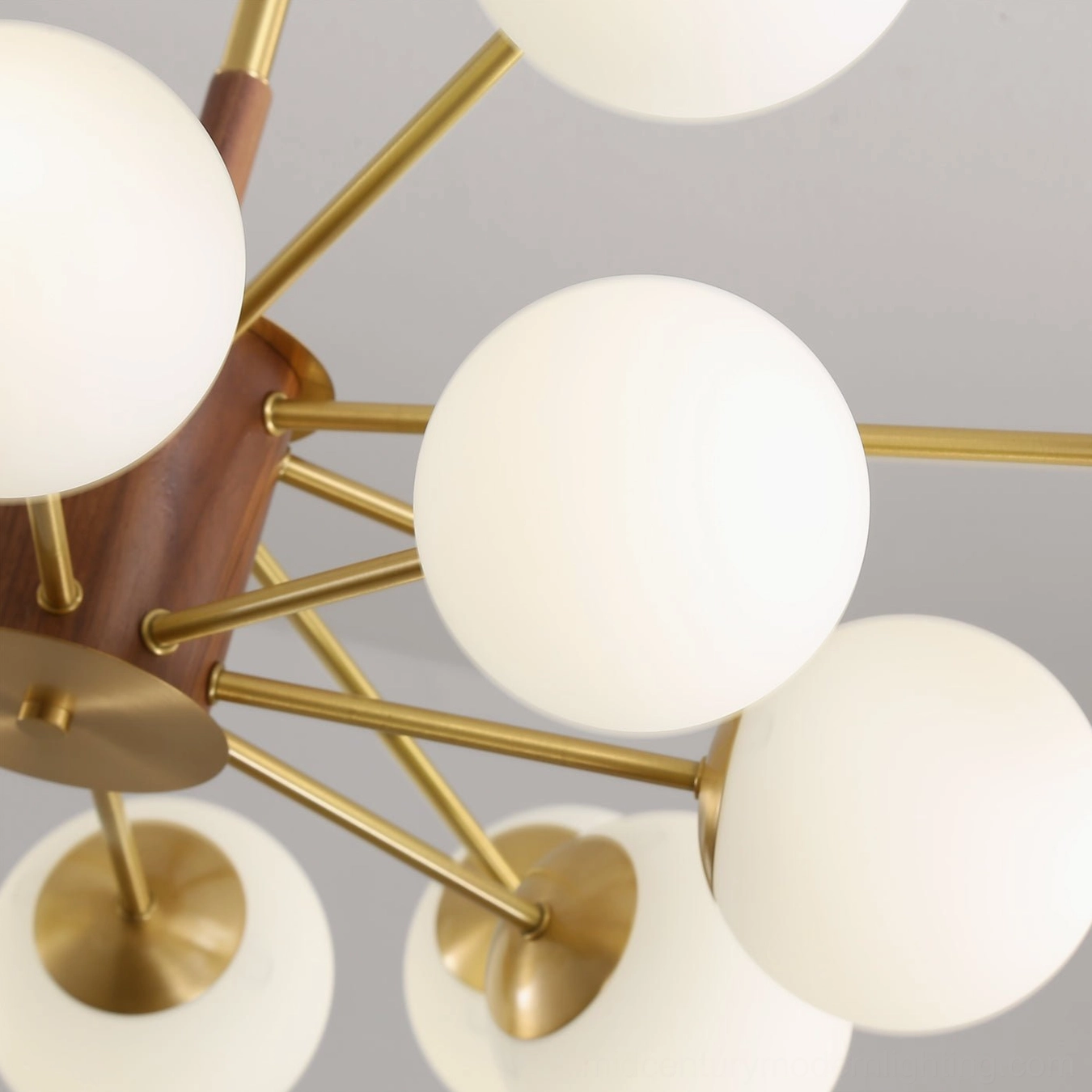Gino brass and wood chandelier full view showing sculptural arm design and globe arrangement