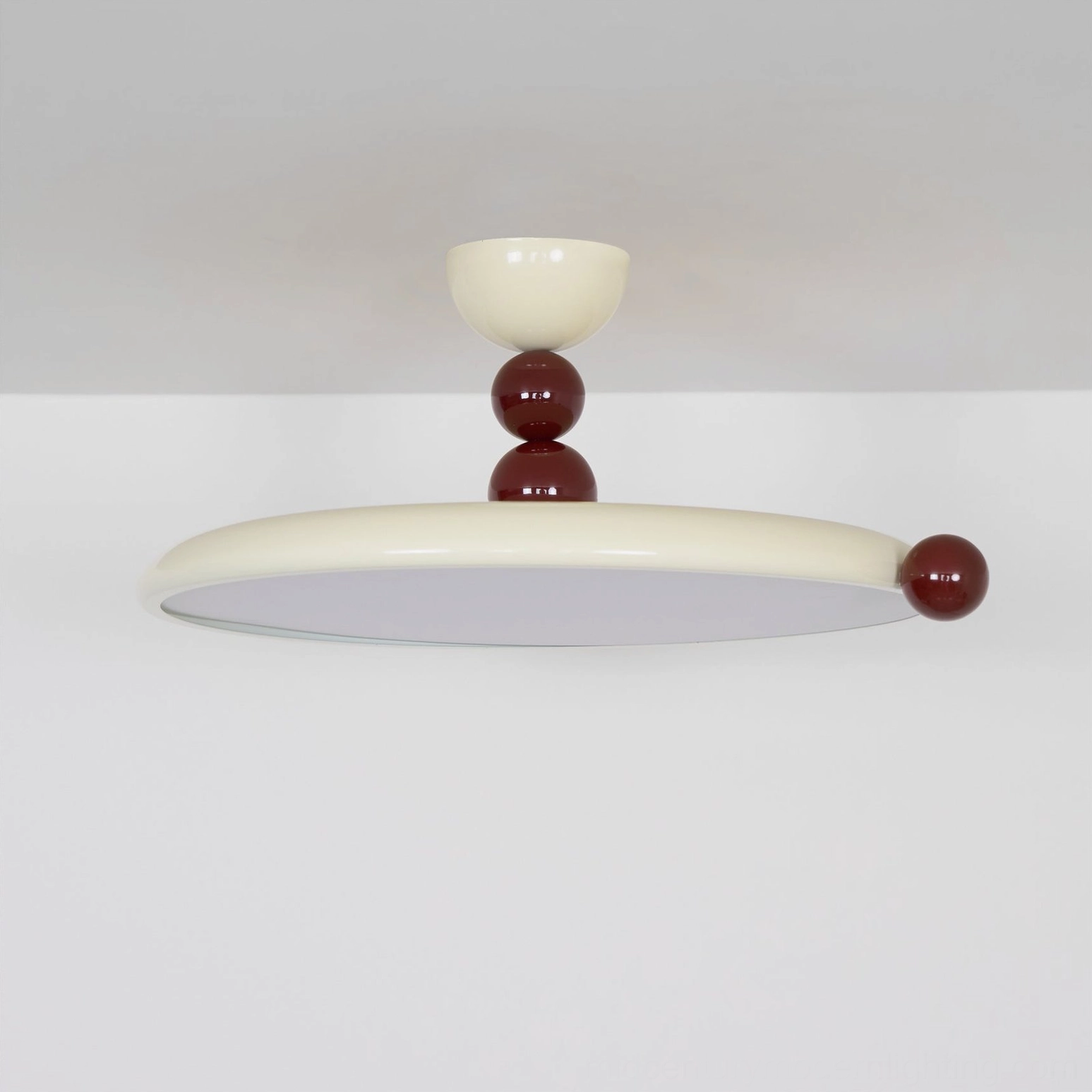 Gino modern ceiling light fixture directly overhead, glowing round diffuser design with warm LED edge accent