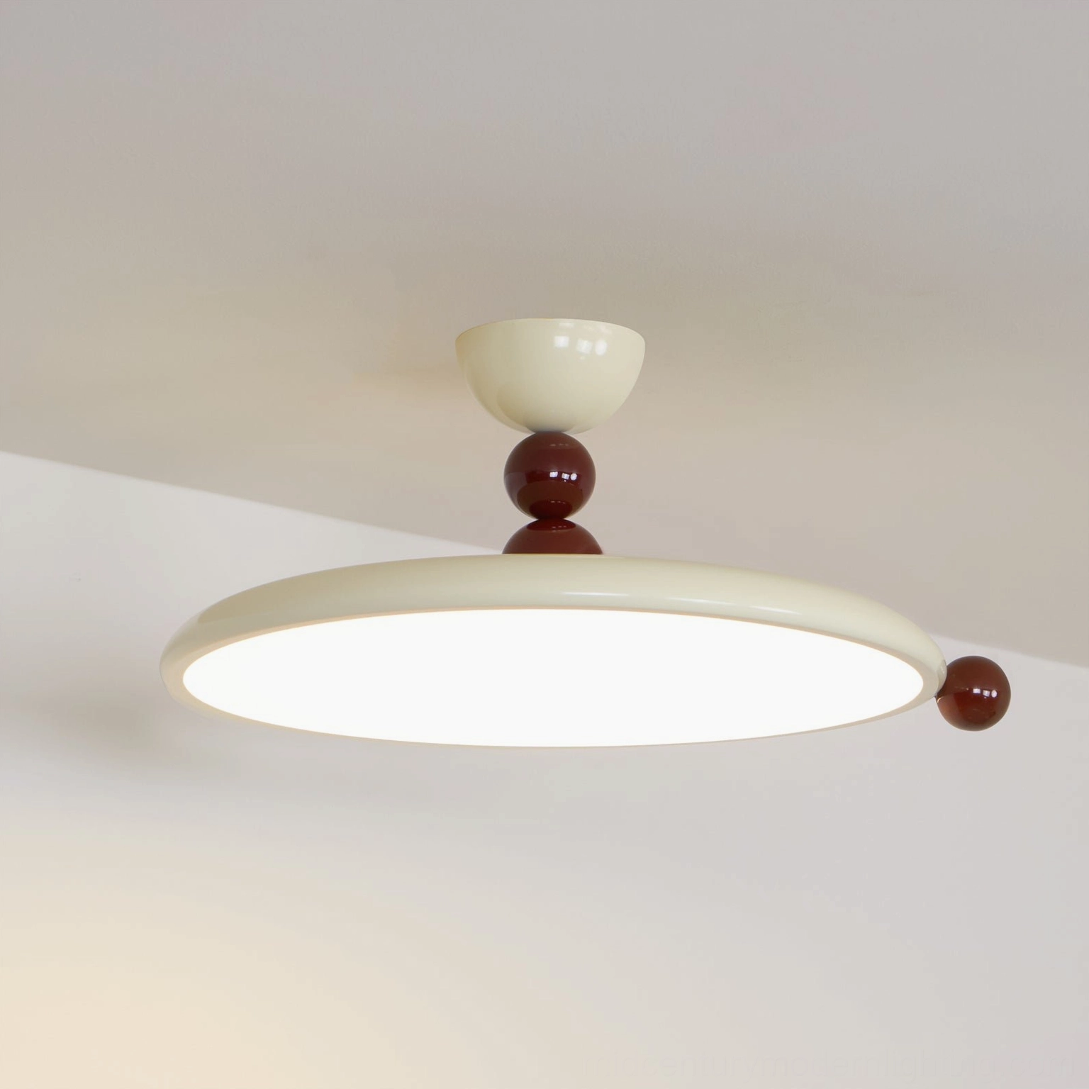 Gino ceiling lamp illuminated with warm LED lighting, overhead angled view showing acrylic diffuser glow