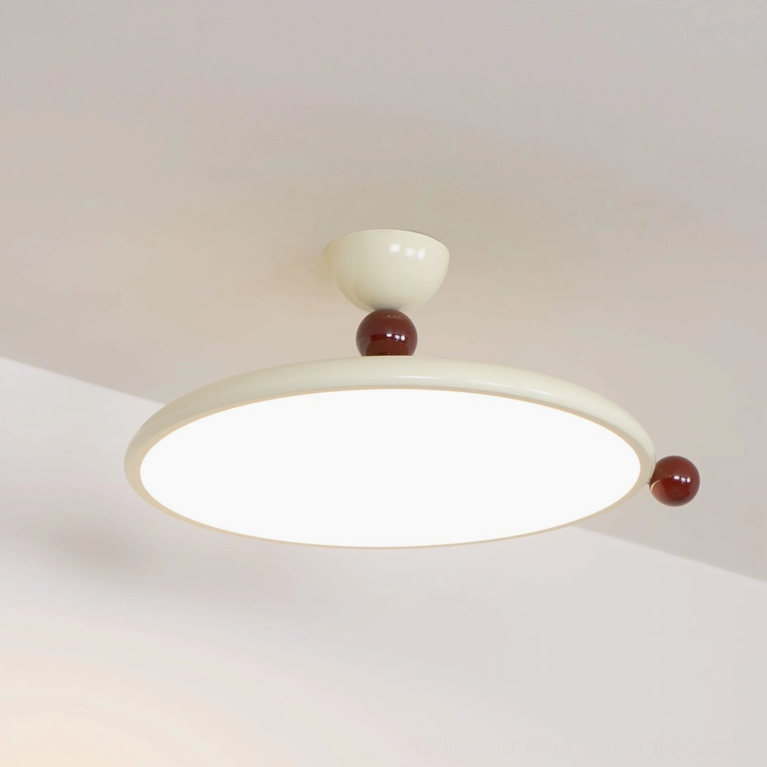 Lit Gino modern ceiling light fixture showing round glowing acrylic diffuser panel, angled overhead perspective