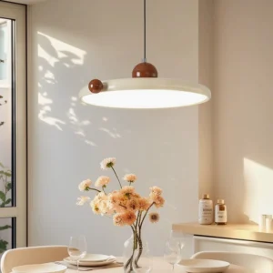 Gino pendant lamp suspended over dining table with floral arrangement creating warm ambient light