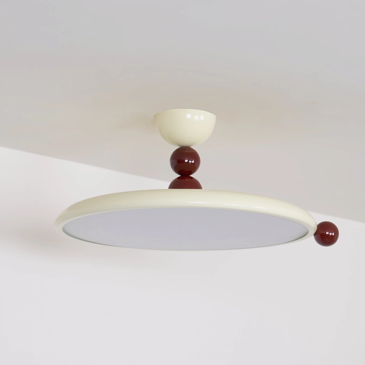 Unlit Gino flush mount ceiling fixture in beige brown finish, side overhead angle on white wall background