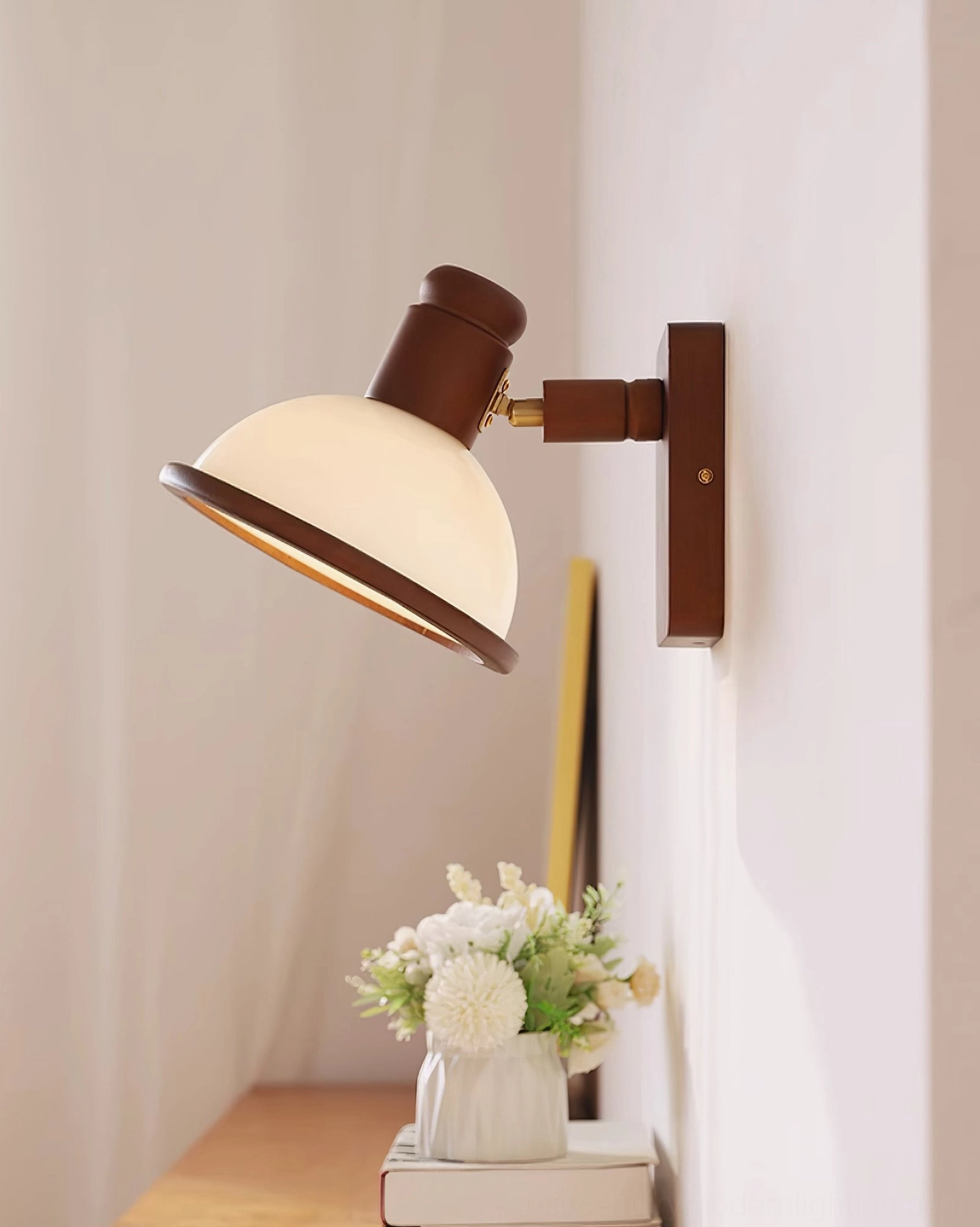 Mid-century wall sconce with exposed Edison bulb design and matte cream metal shade in compact corner space