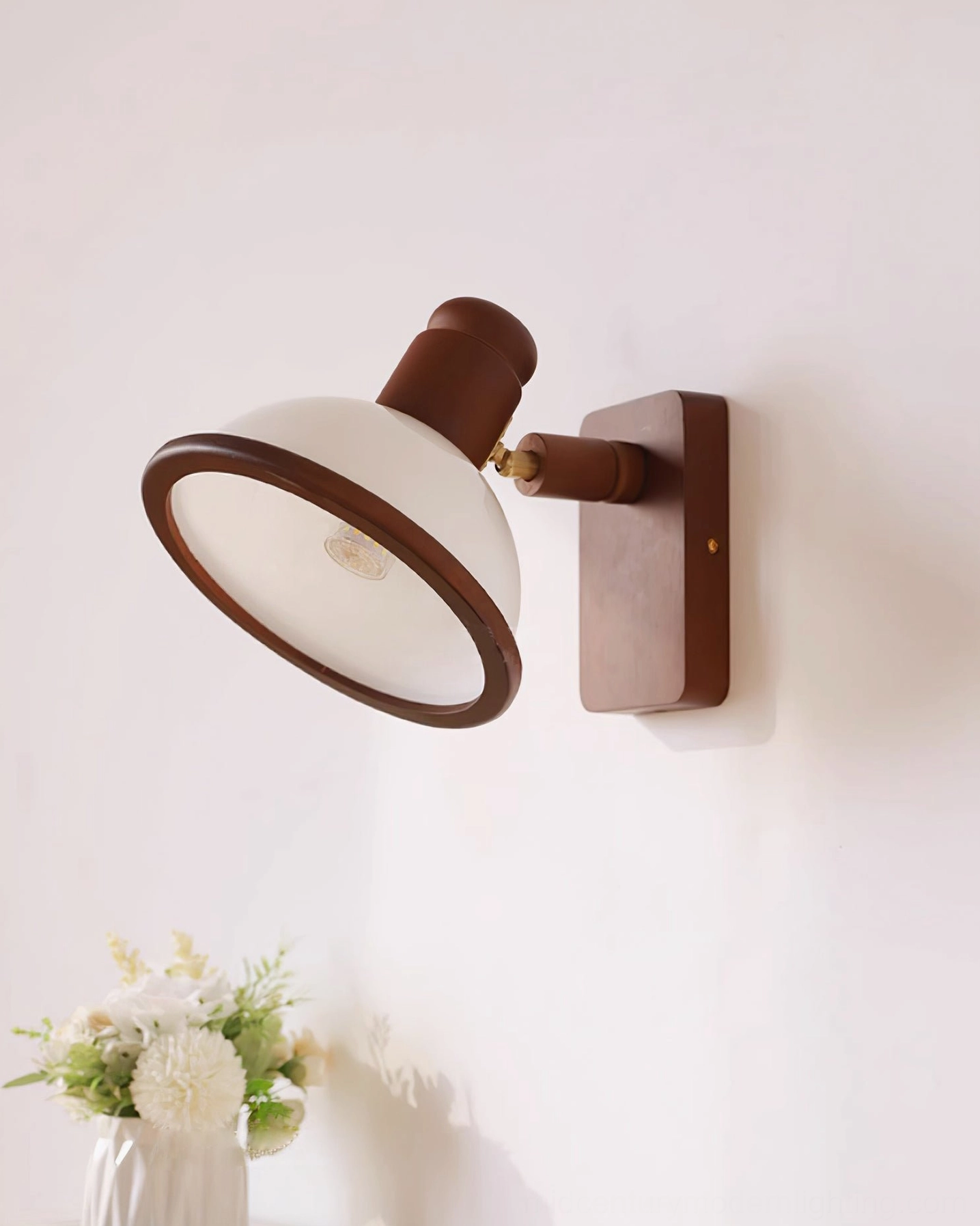 Open dome shade wall lamp in brown wood and off-white finish, bottom front perspective on white background