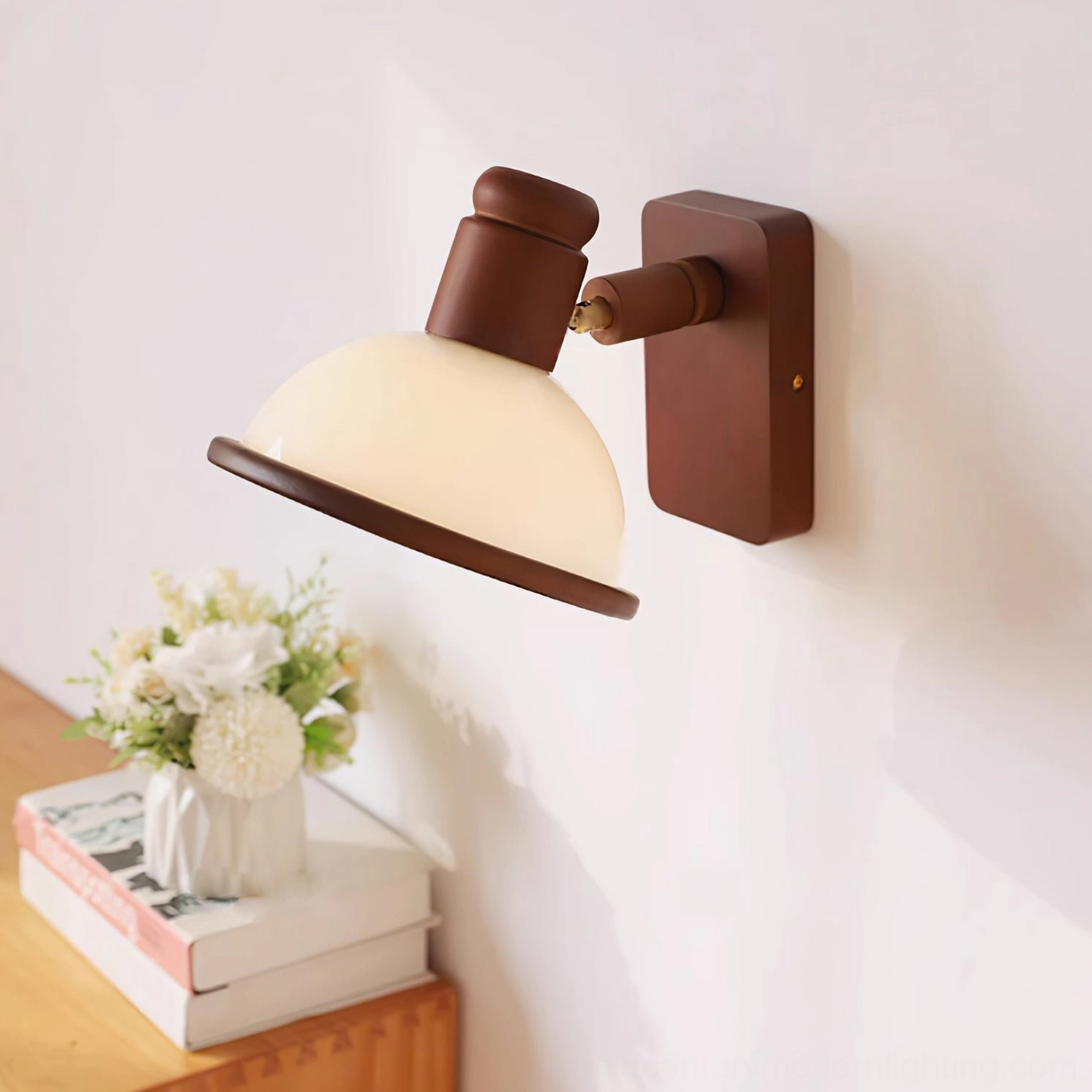 Vintage two-tone wall lamp with brown trim and cream shade, displayed on wooden side table with floral arrangement
