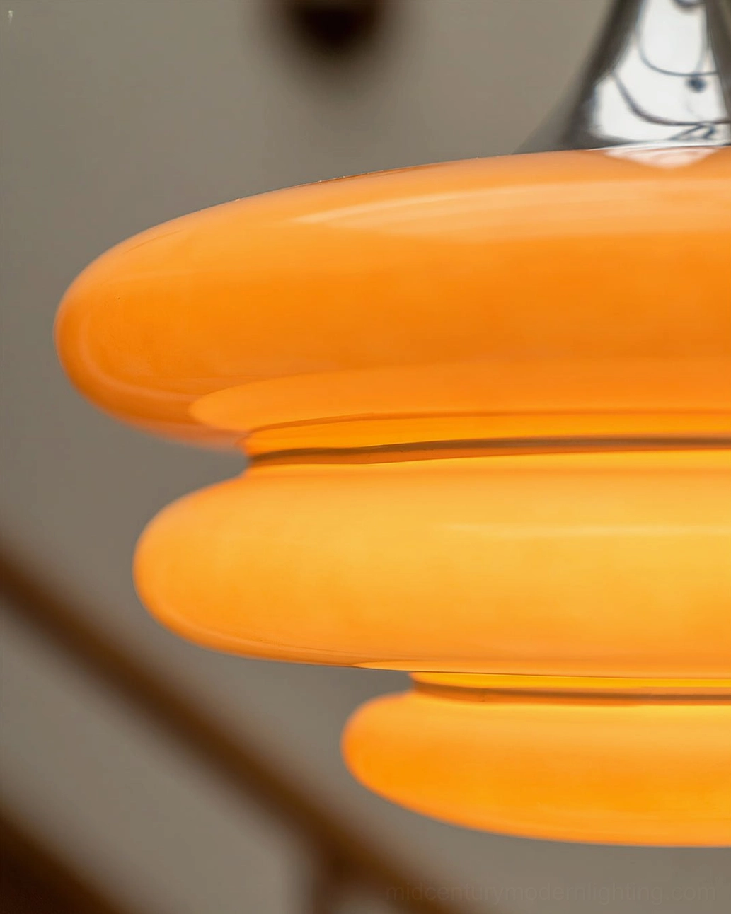 Close-up macro detail smooth glossy orange layered glass discs subtle texture tiered structure