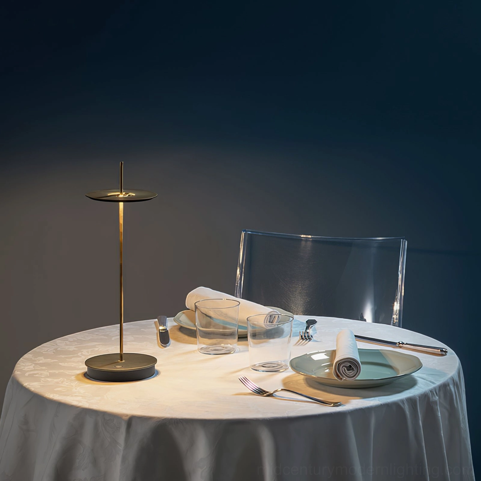 Matte black Giulietta minimalist disc table lamp on formal dining table with contemporary place settings