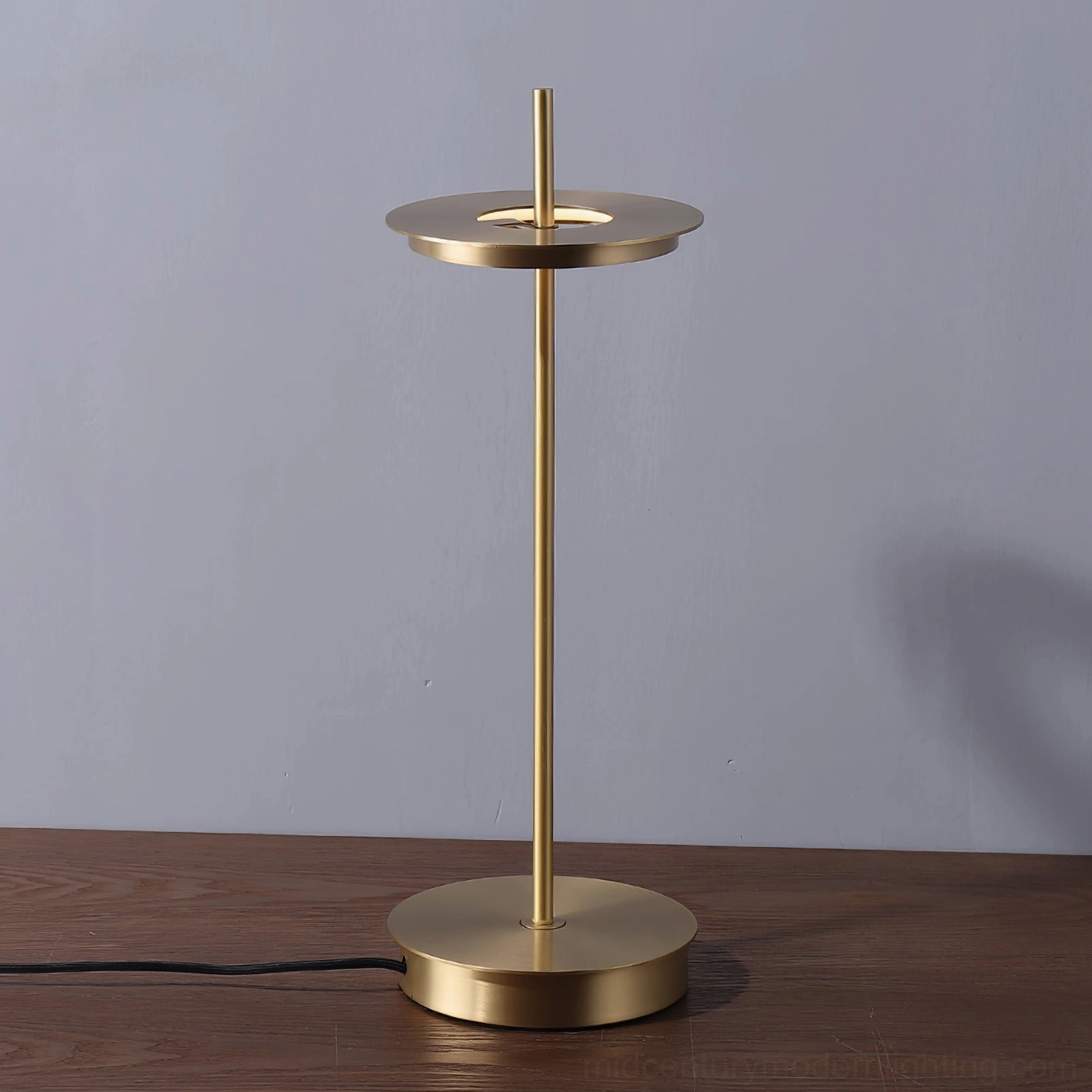 Warm brass Giulietta table lamp creating sophisticated lighting for formal dinner table setting