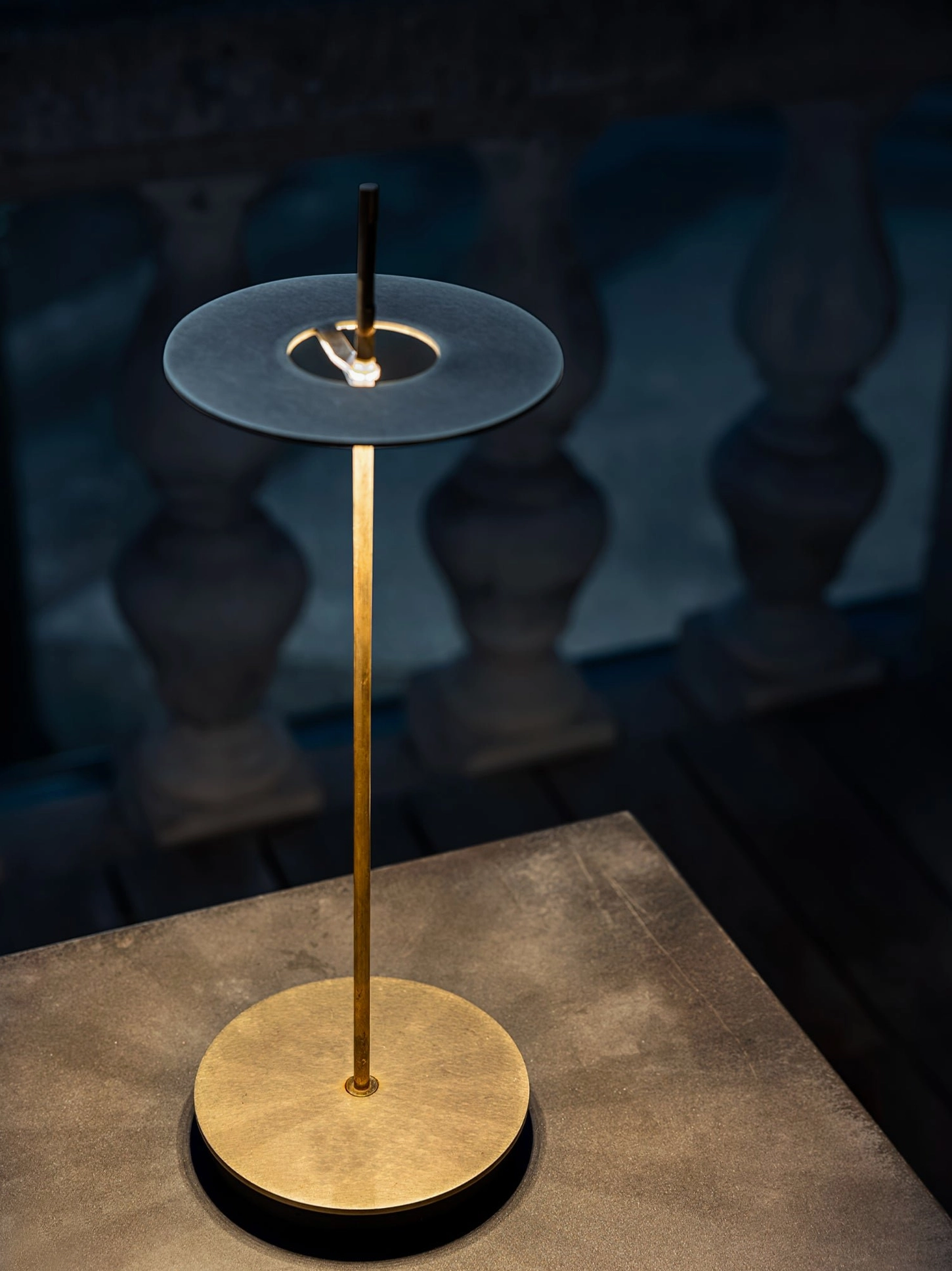 Polished brass Giulietta table lamp showing warm ambient lighting in contemporary interior space