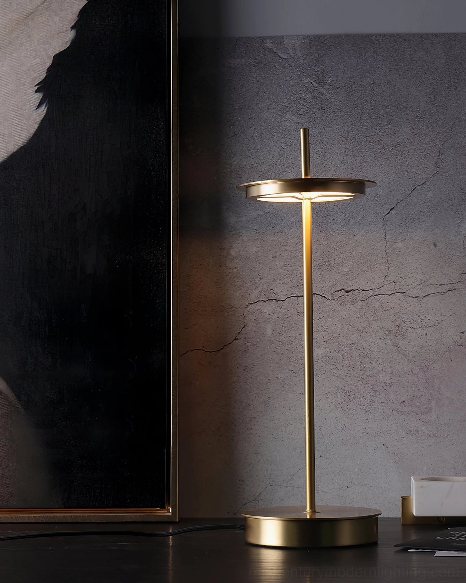 Giulietta minimalist table lamp in gold finish styled on contemporary home office desk workspace