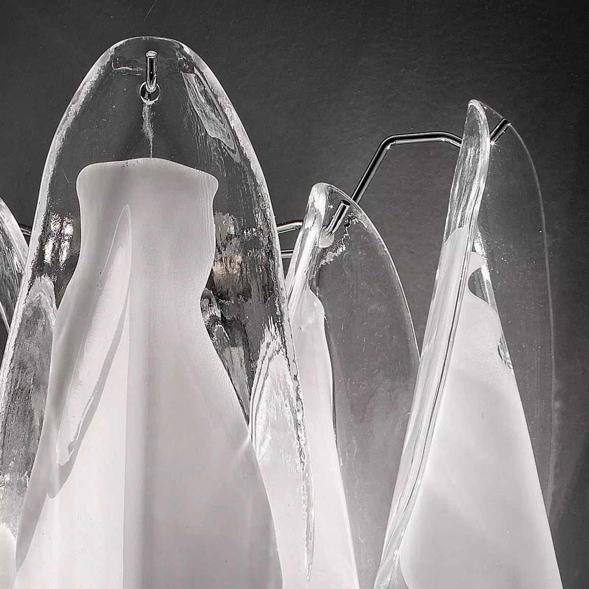 Close-up detail of Glacier wall lamp glass edges and textured surface with mounting hardware