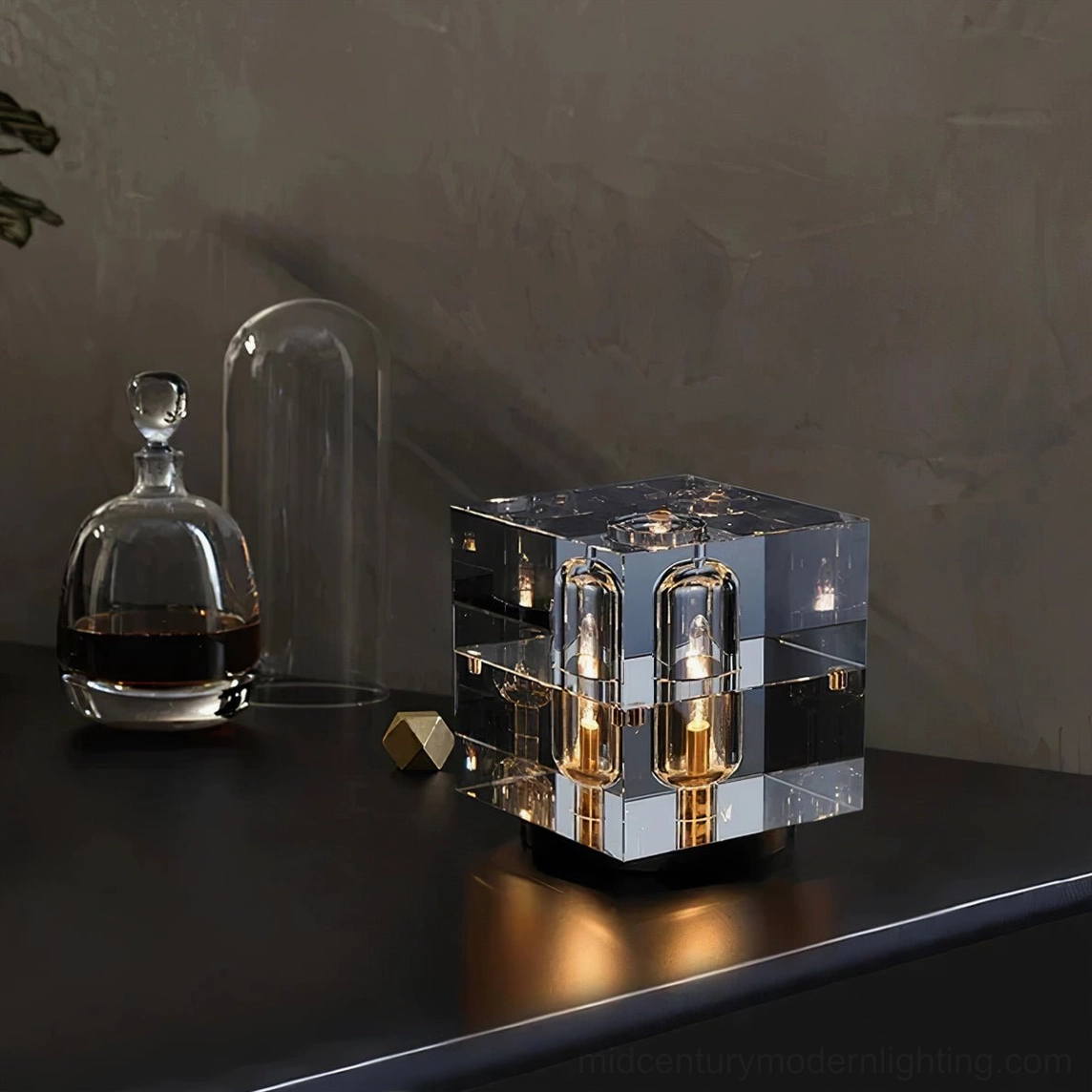 Glacon Cube optical crystal table lamp with 4 filament bulbs on dark wood console, luxury minimalist style