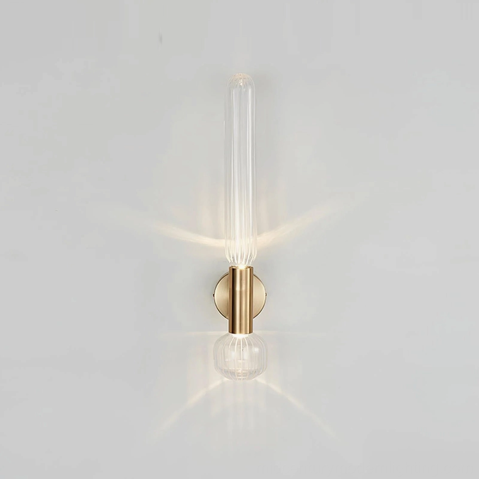 Glaive compact wall sconce 19.3 inches, brushed gold metal and ribbed glass, studio background