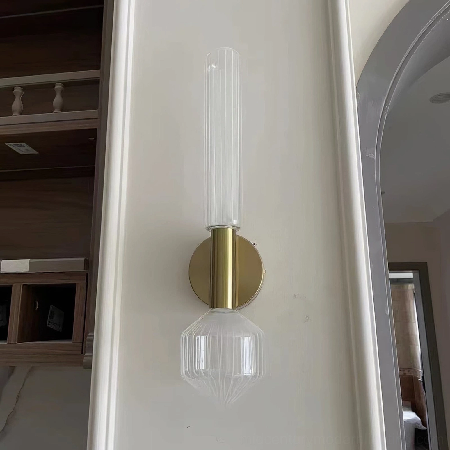 Glaive wall lamp in modern home entryway hallway, contemporary luxury interior lighting design