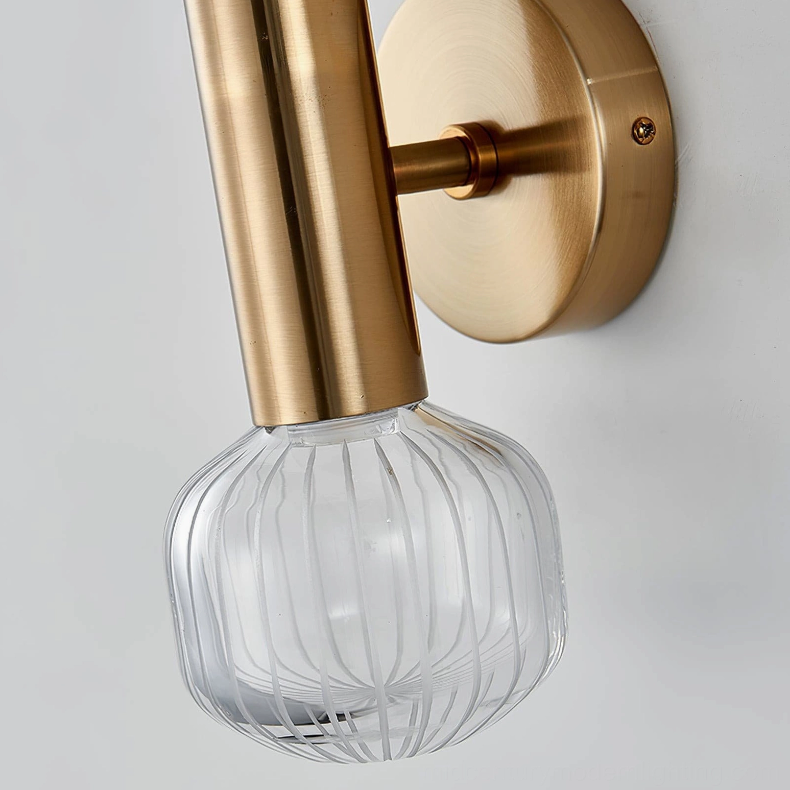 Glaive wall sconce finish detail, brushed gold metal surface texture and quality construction