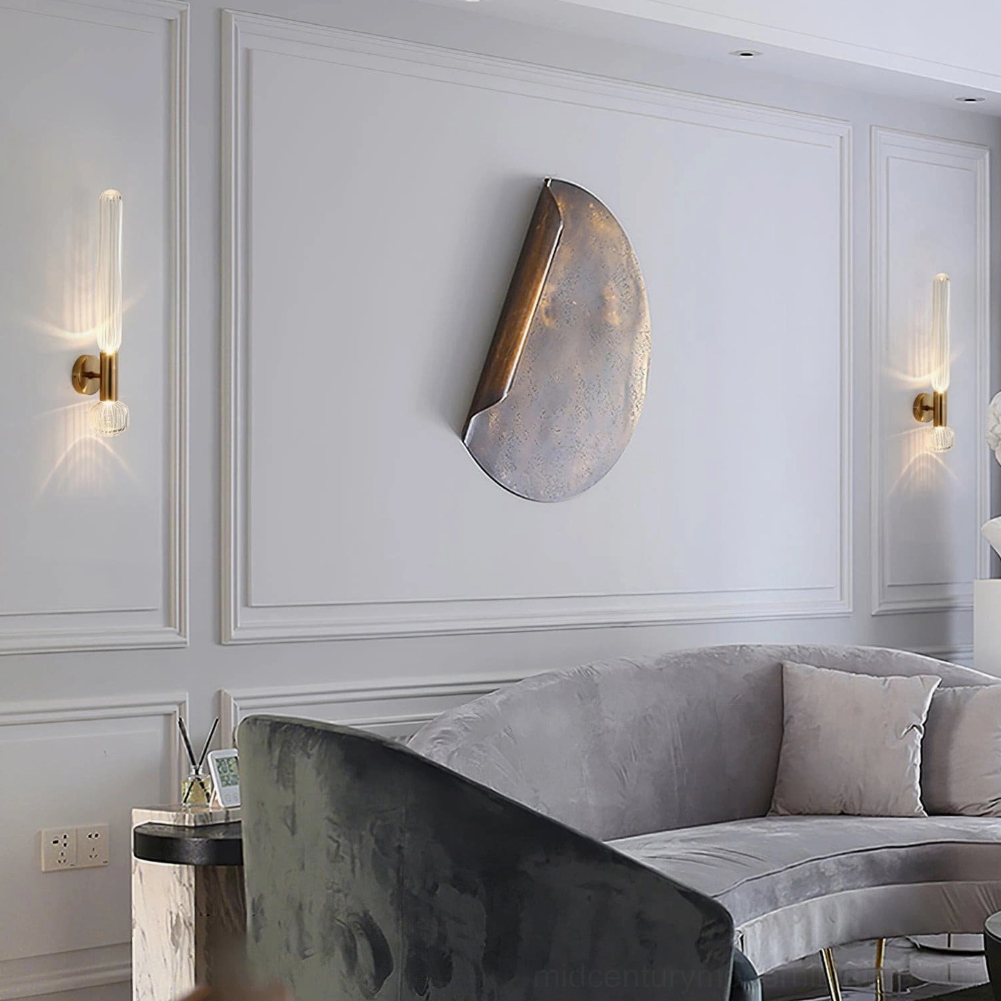 Pair of Glaive wall sconces in living room with modern grey sofa and contemporary art wall decor