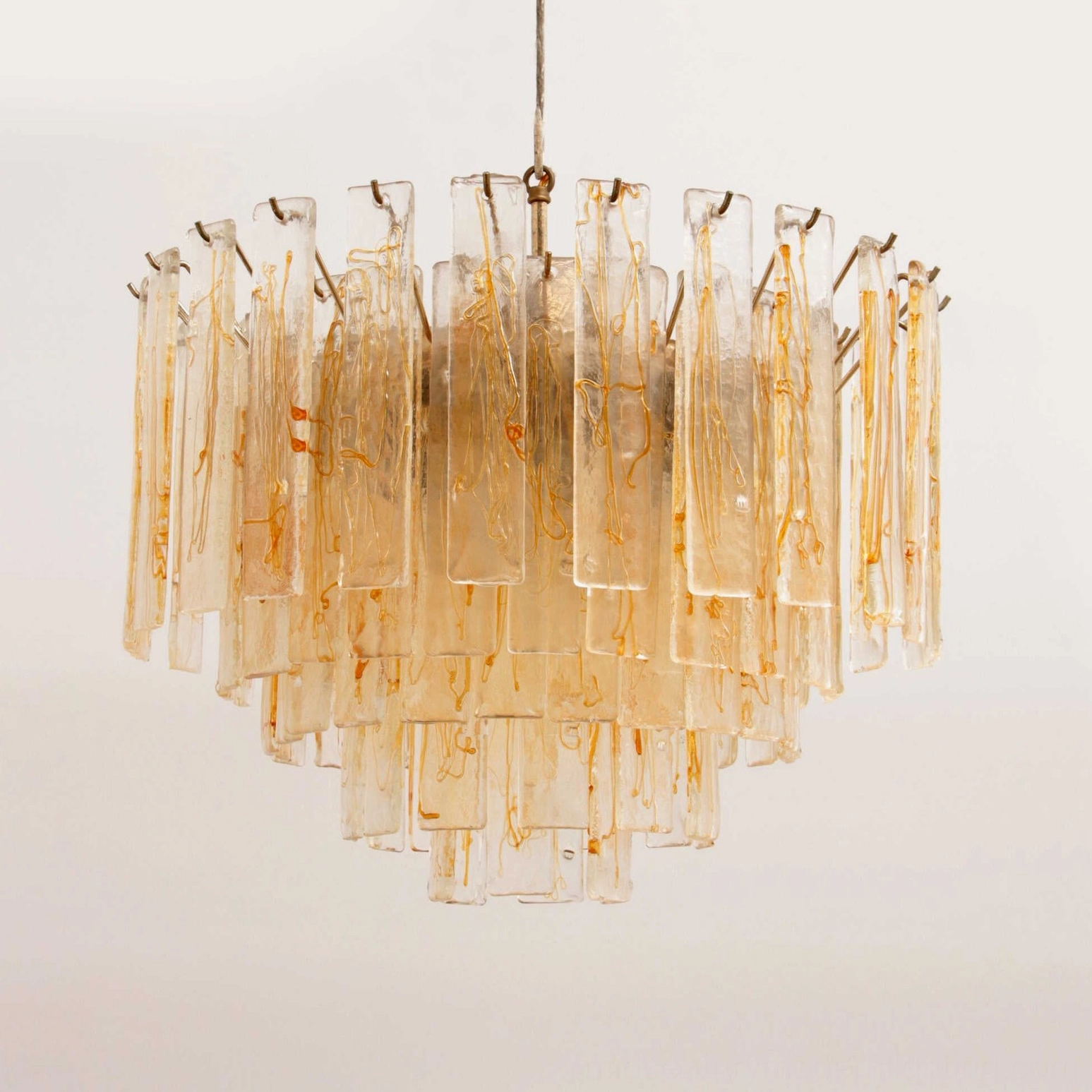 Elevated perspective of layered glass chandelier showing hanging suspension rod and architectural tier construction