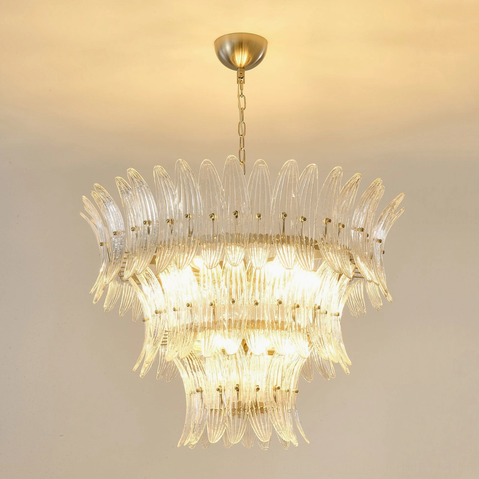 Full view of tiered glass palm chandelier showing complete cascading palm frond glass structure with bulb configuration