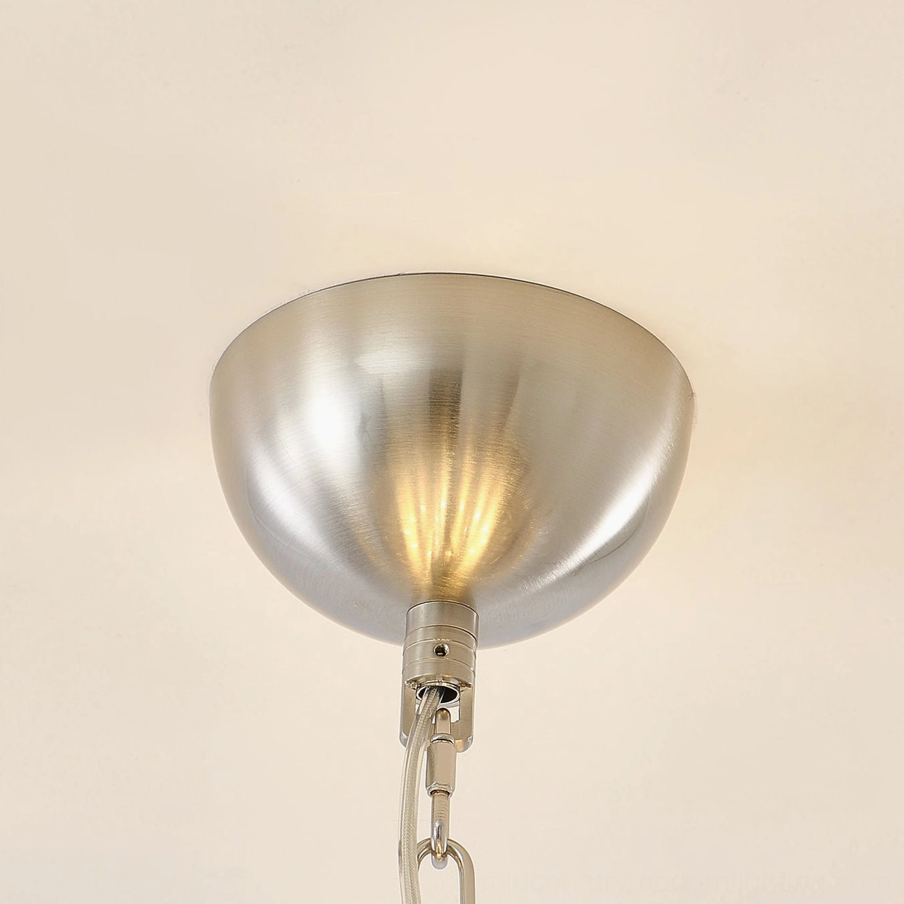 Illuminated glass palm chandelier demonstrating warm light diffusion through layered frosted glass layers