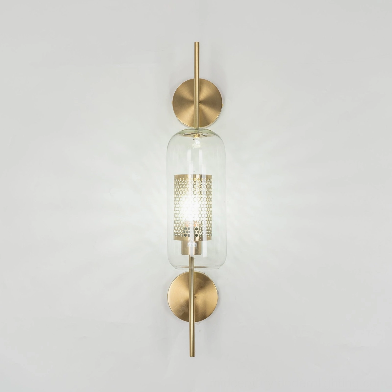 Glass wall sconce mounted on neutral interior wall, modern lighting installation