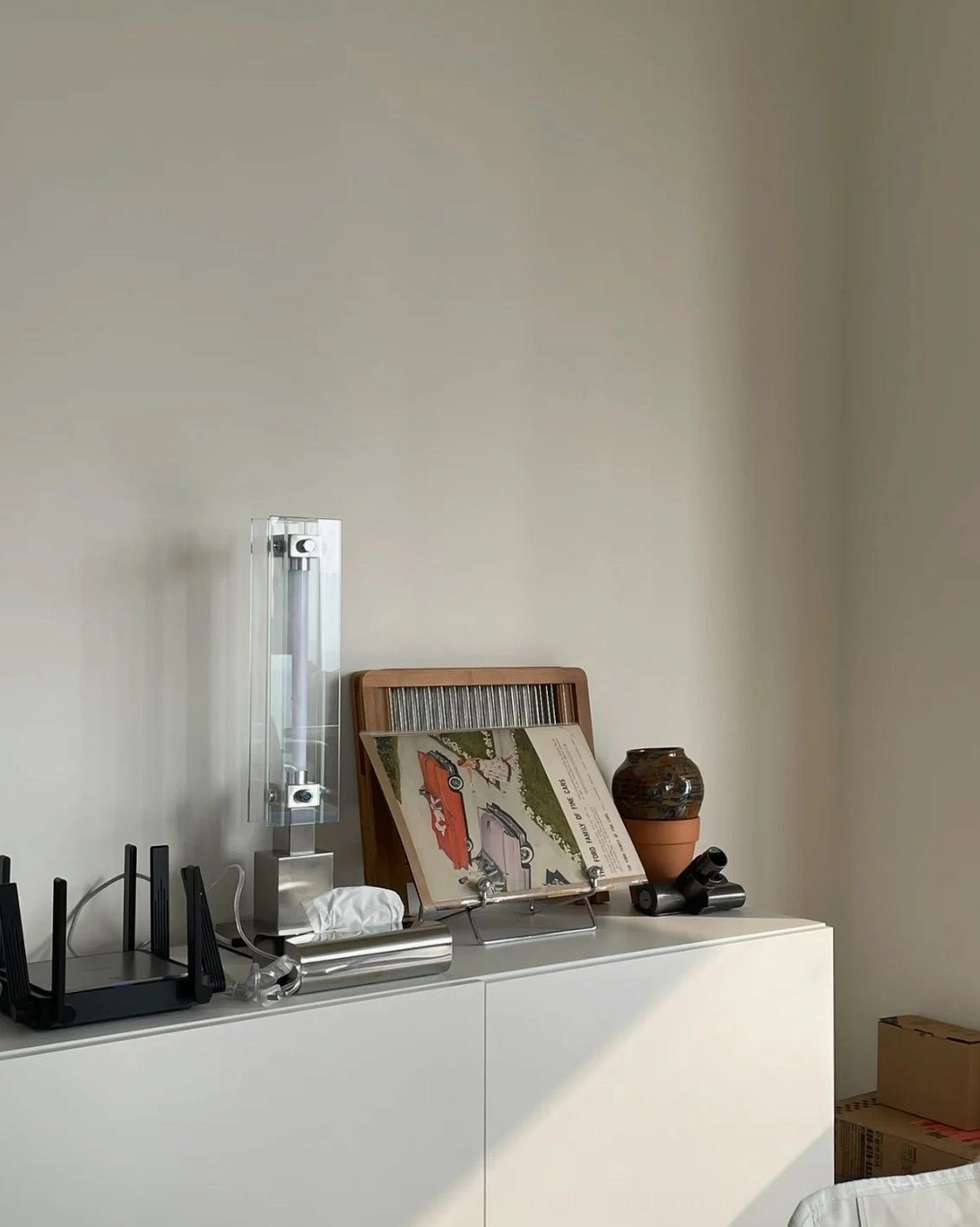Side view of sleek glass and chrome lamp showing silhouette and light diffusion characteristics