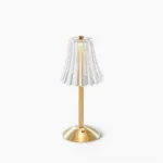 Glitters gold table lamp with ribbed clear glass shade, front studio view showcasing Art Deco-inspired design