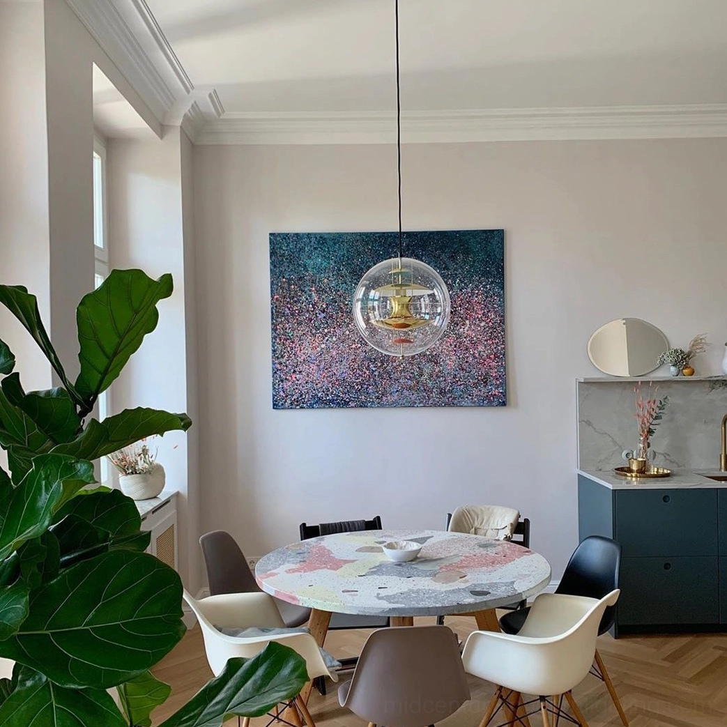 Globe ceiling pendant in stylish interior setting with coordinating furniture and decor