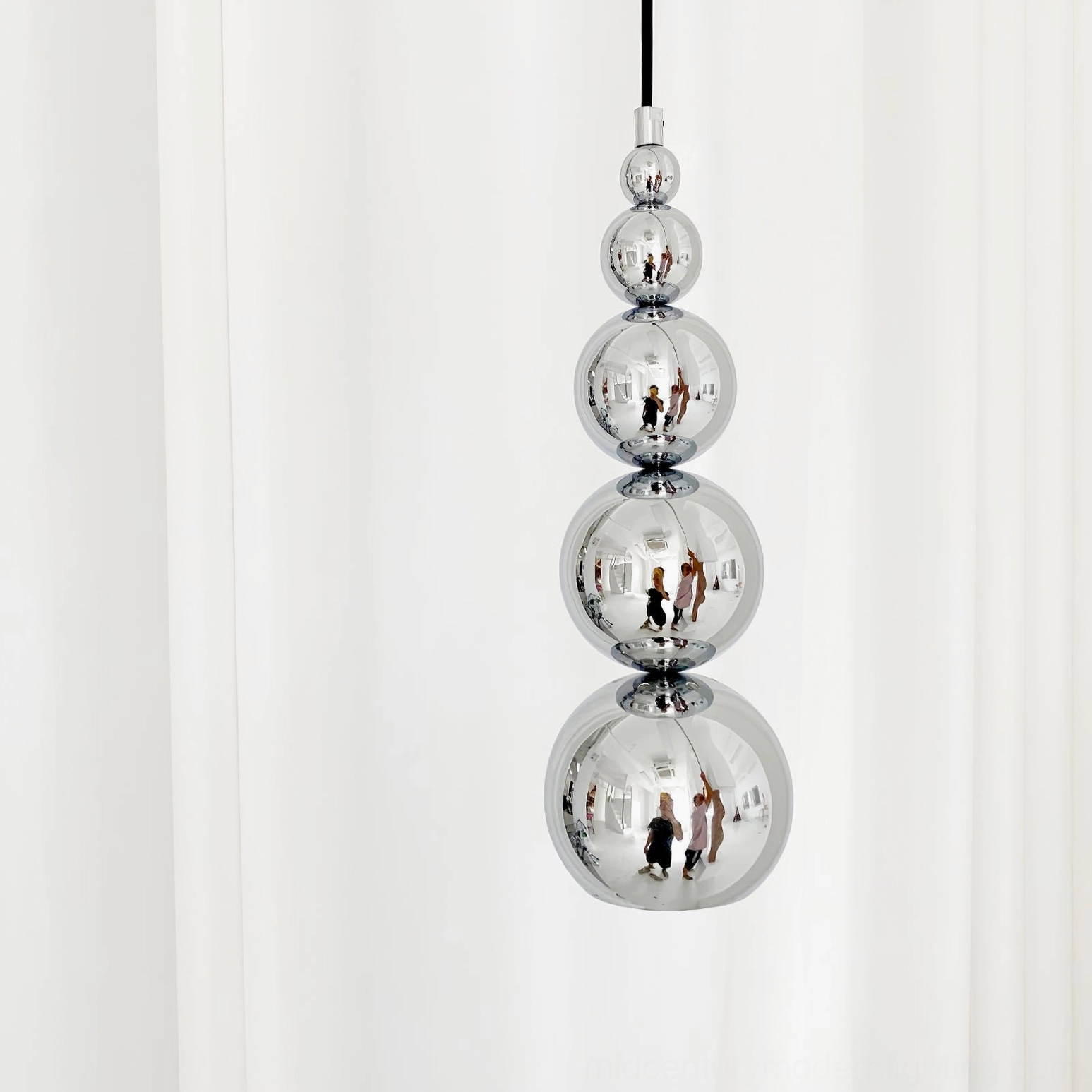Globe pendant light emphasizing descending bubble silhouette and elegant sculptural presence