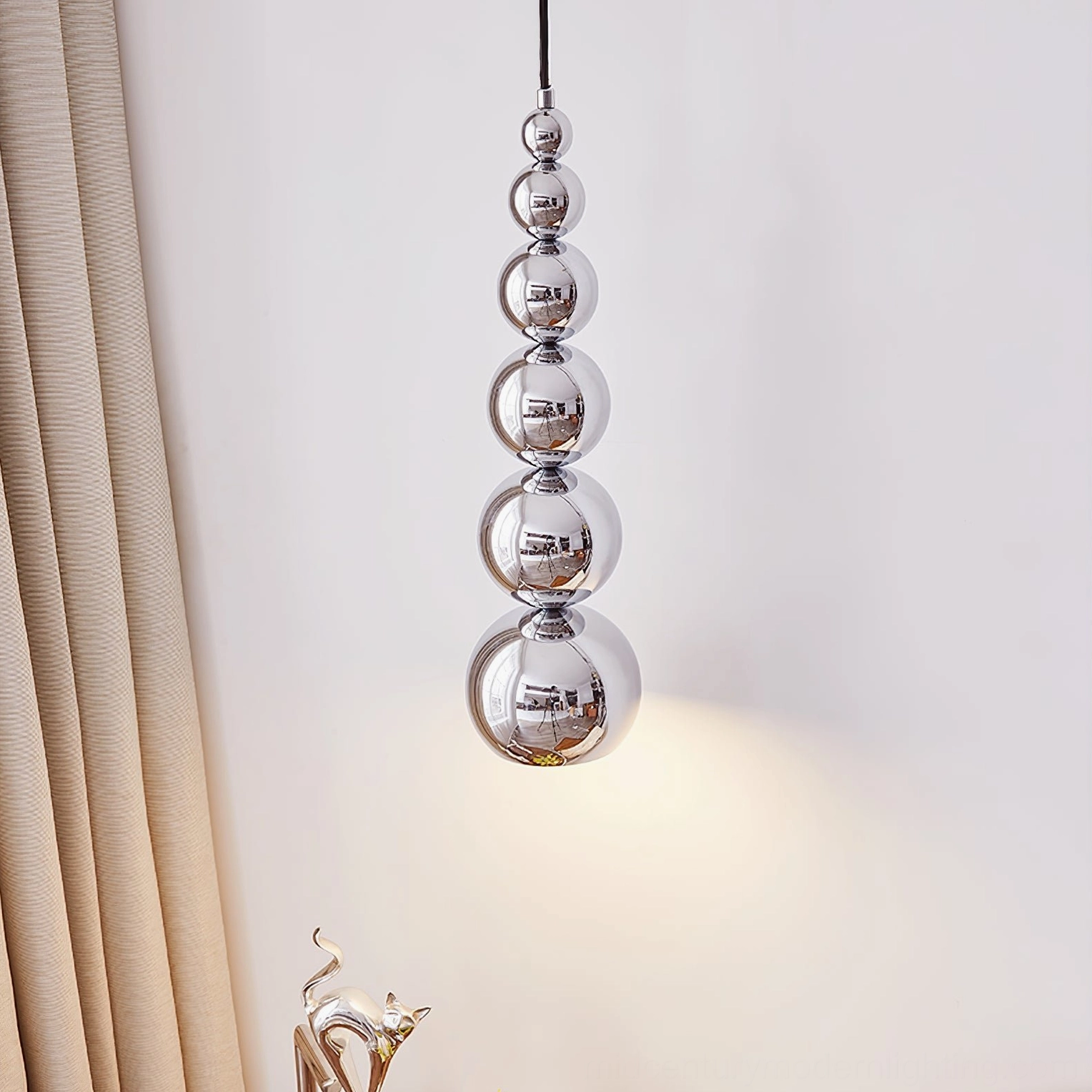 Chrome globe pendant light fixture detail view emphasizing polished reflective metalwork and craftsmanship