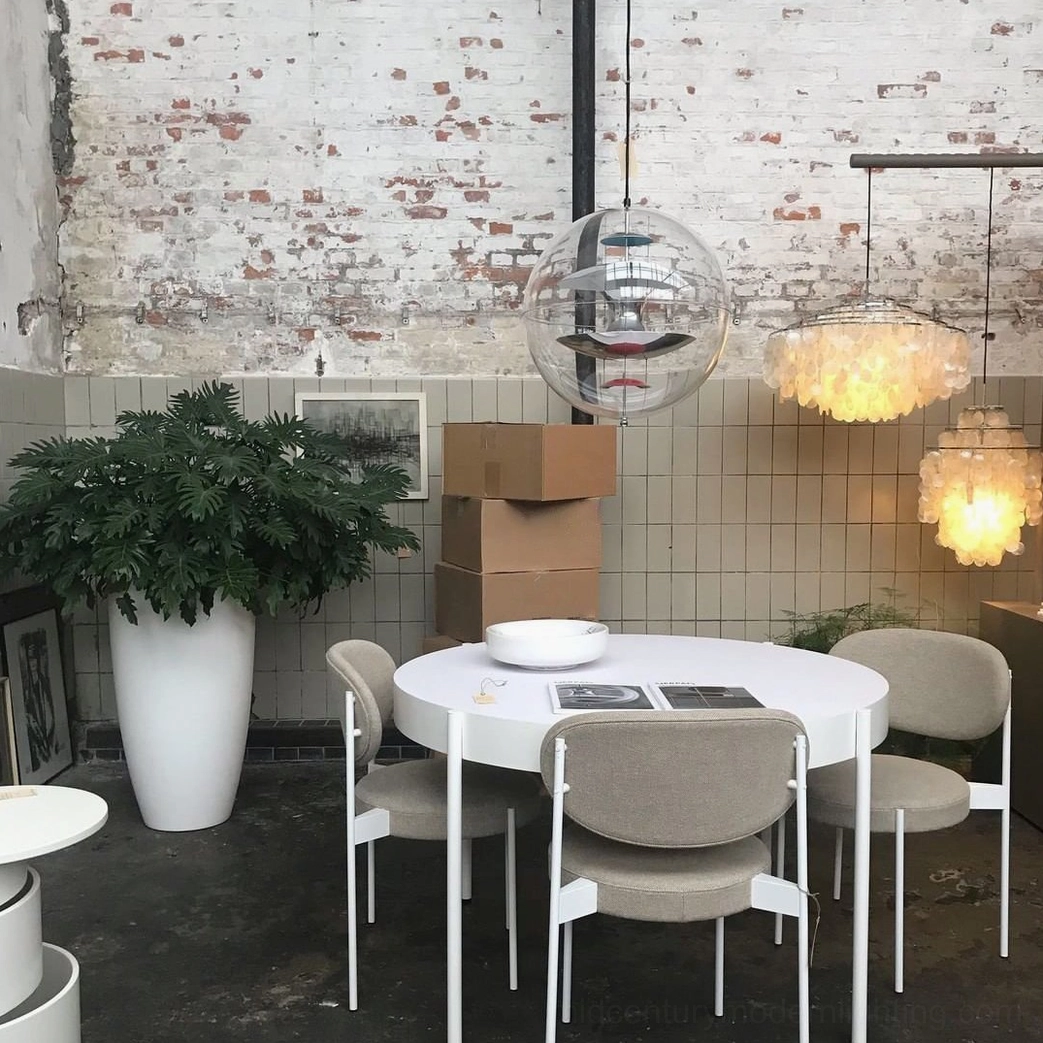 Globe pendant lamp with warm glow illuminating dining or work space