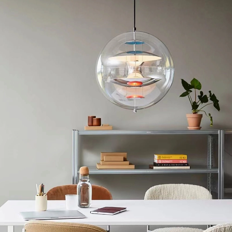 Globe pendant light in minimalist workspace with metal shelf, front view showing multi-toned interior