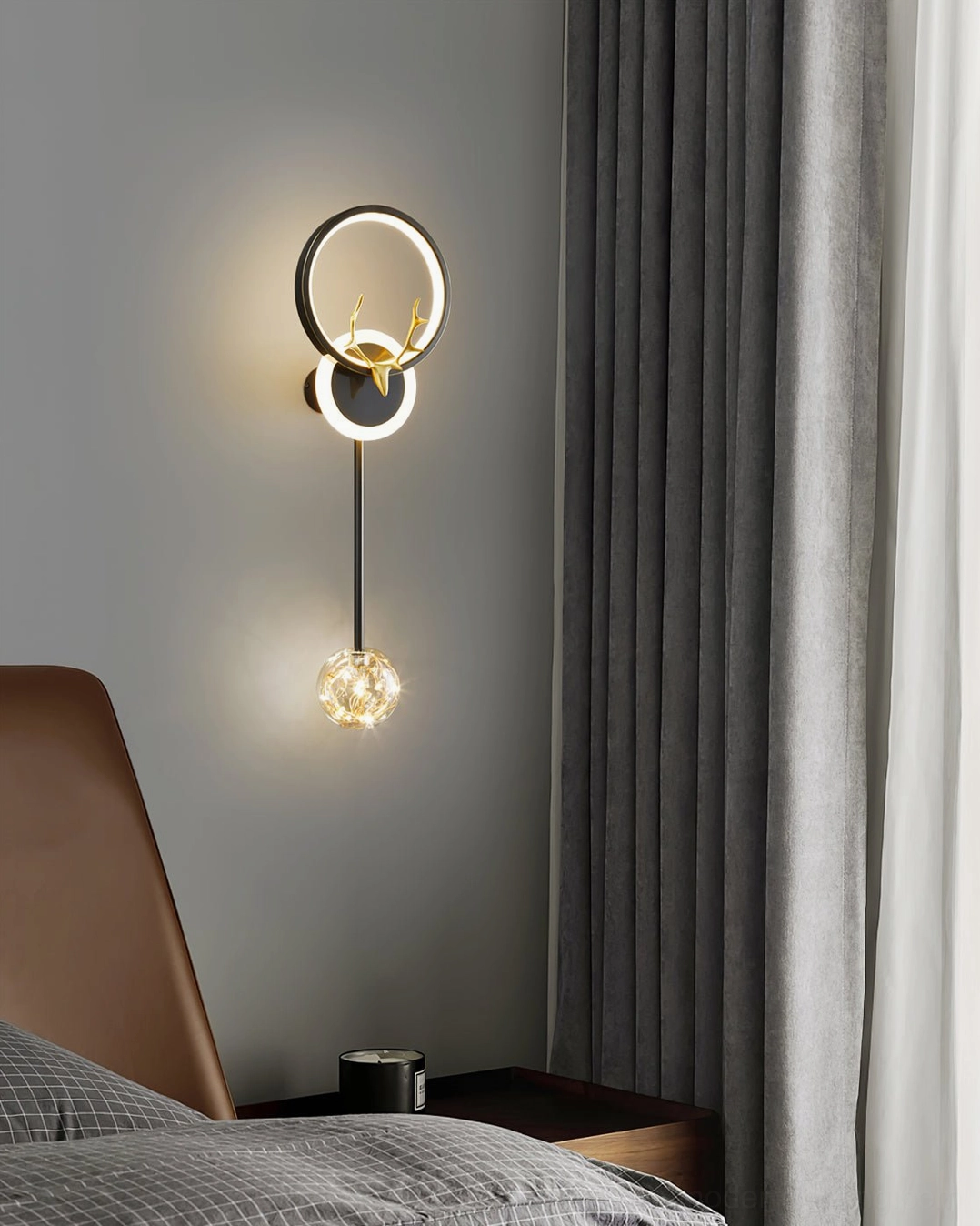 Gold antler wall sconce in modern bedroom bedside with sheer curtain backdrop and contemporary design