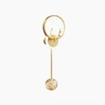 Gold antler wall sconce with ring frame design and glass pendant, modern nordic style lighting on white studio background