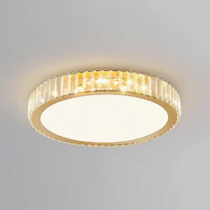 Lit round crystal ceiling lamp glowing warm golden light against white ceiling