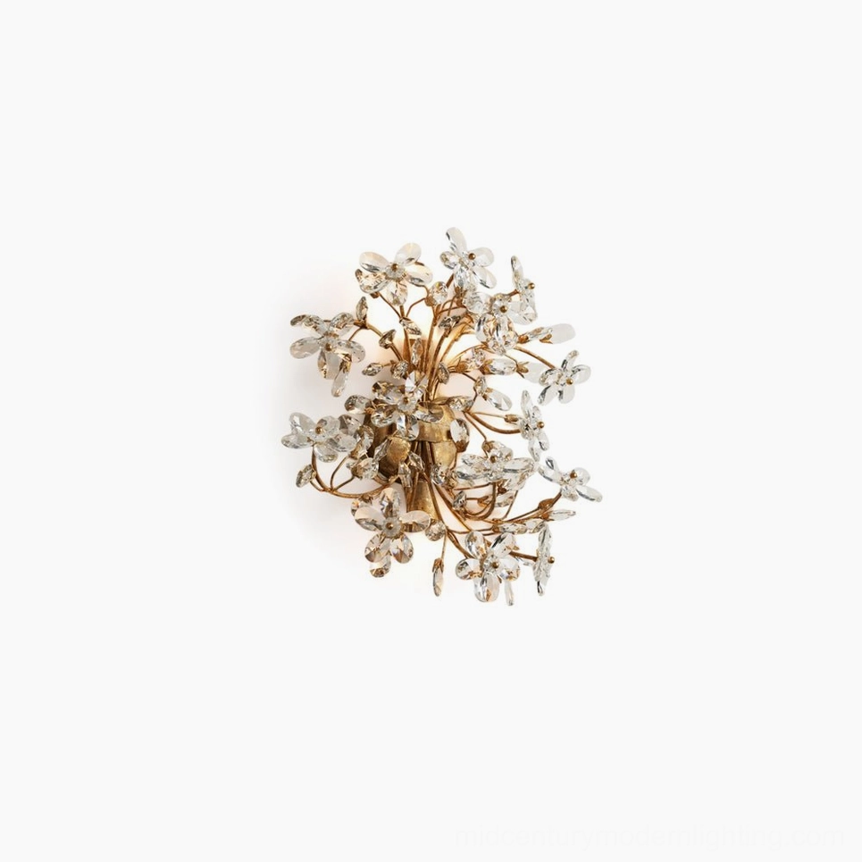 Crystal flower wall sconce with warm gold finish, overhead studio view, delicate faceted crystal petals arranged in botanical clusters