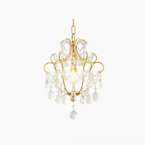 Gold crystal pendant lamp with clear faceted teardrop crystals and scrollwork metal frame in studio lighting