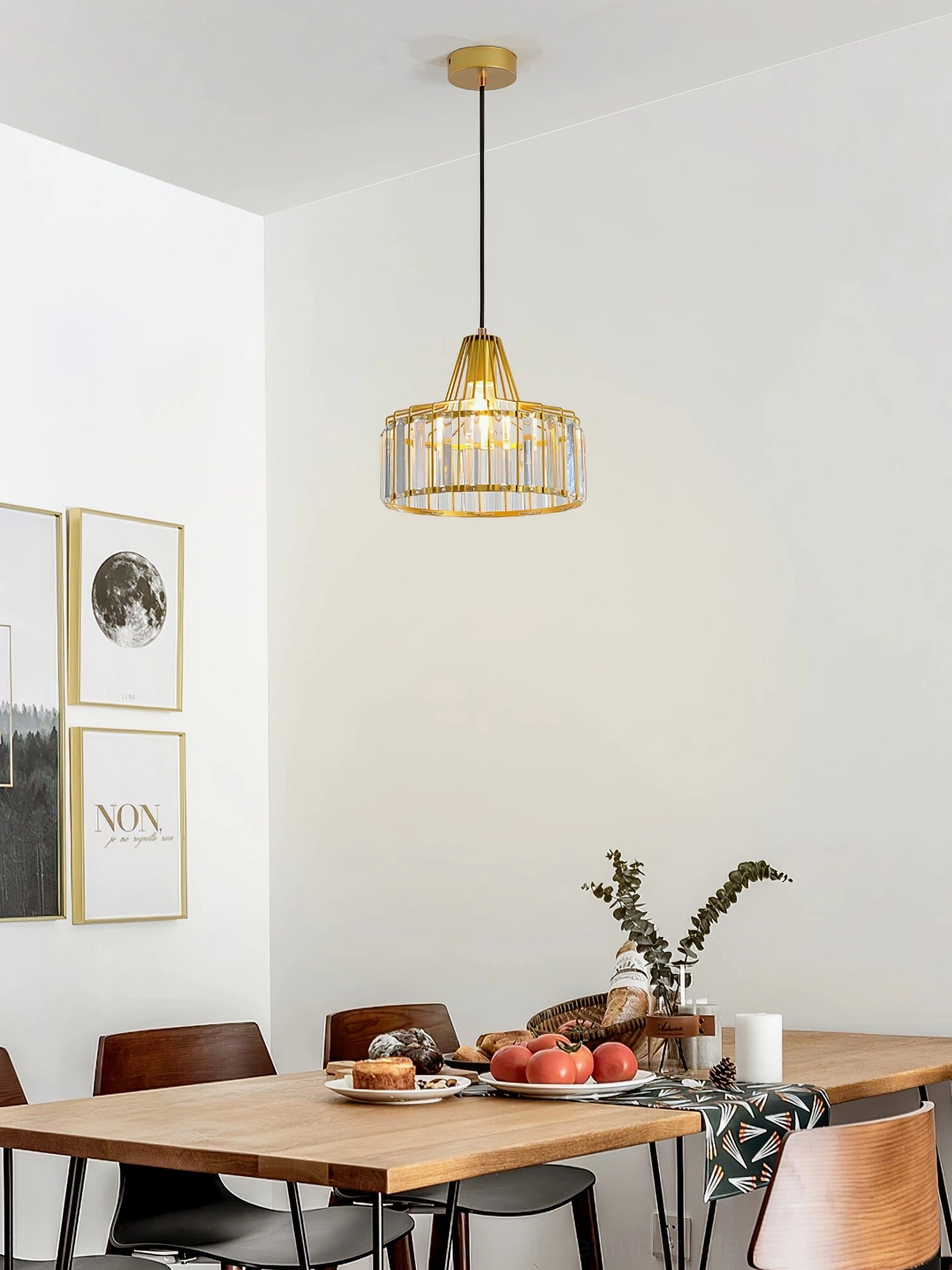 Gold crystal cage pendant lamp with warm luxury aesthetic above modern dining room table