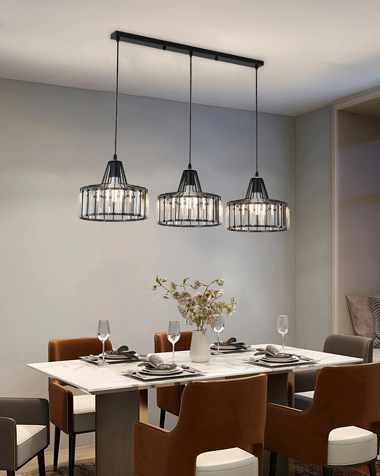 Crystal pendant light with gold metal frame over dining area with modern wall artwork decor