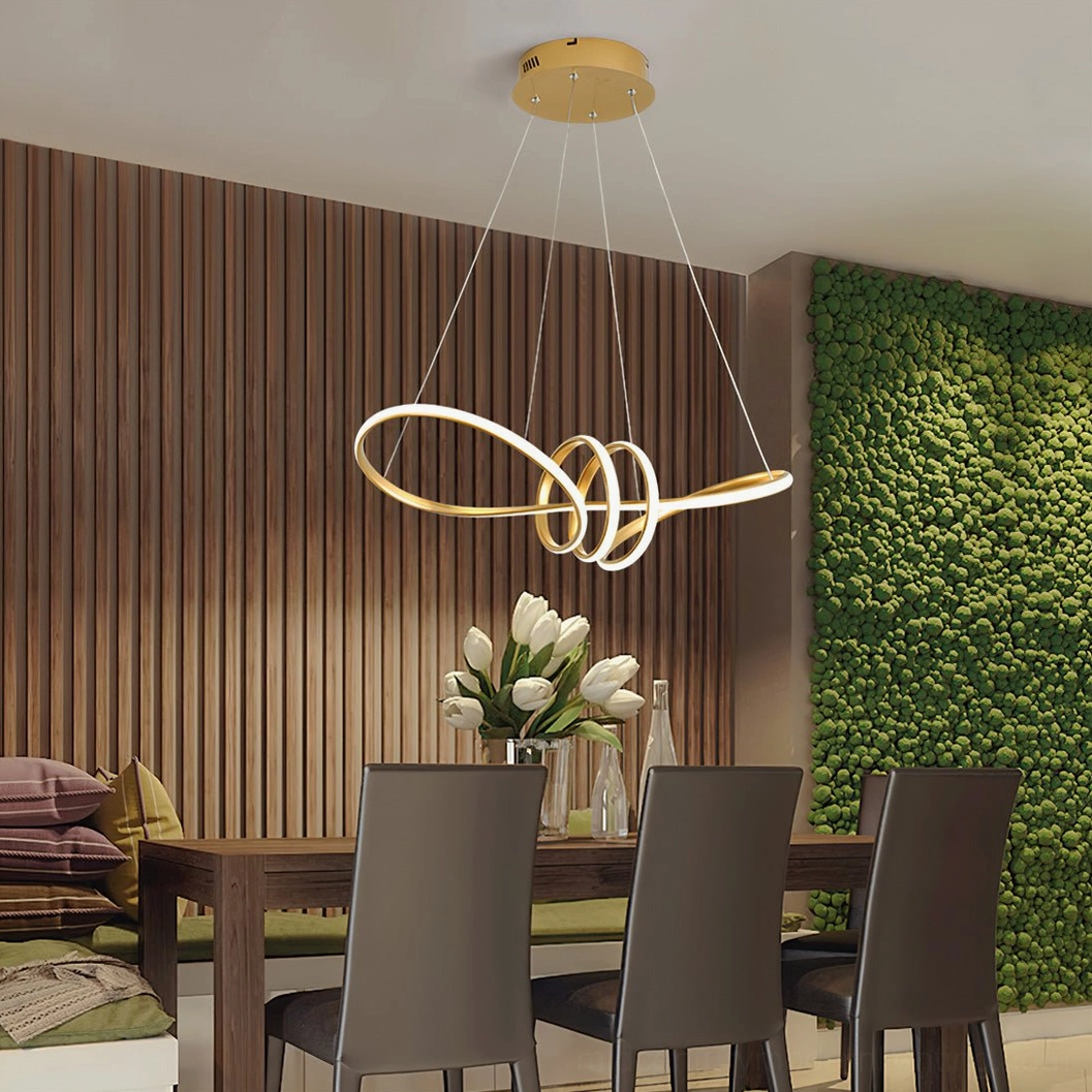 Modern dining room with green feature wall, gold infinity twist double loop LED chandelier displaying elegant minimalist design