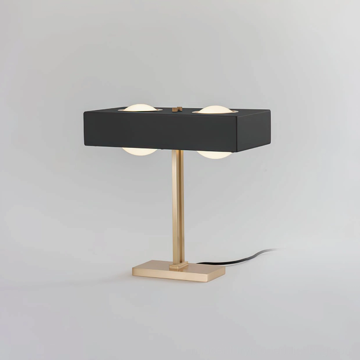 Gold finish Kernel table lamp with warm glow showing vintage mid-century modern aesthetic
